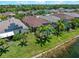 Aerial view of a home with a pool, screened lanai, and manicured lawn at 10131 Winding River Rd, Punta Gorda, FL 33950