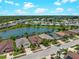 Aerial view of the houses, pond, and landscaping at 10131 Winding River Rd, Punta Gorda, FL 33950