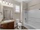 Bright bathroom with a granite vanity, shower-tub combination and tiled floors at 10131 Winding River Rd, Punta Gorda, FL 33950