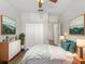 Bright bedroom with a ceiling fan, closet and neutral decor with a painting on the wall at 10131 Winding River Rd, Punta Gorda, FL 33950