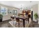 Formal dining area featuring stylish decor, wood floors, and sliding glass doors with a view of the pool at 10131 Winding River Rd, Punta Gorda, FL 33950
