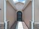 Inviting front entrance with a screened-in door, stone accents, and a tidy walkway at 10131 Winding River Rd, Punta Gorda, FL 33950
