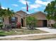 Well-maintained single-Gathering home with lush front yard, mature landscaping, and an American flag at 10131 Winding River Rd, Punta Gorda, FL 33950