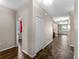 Hallway with hardwood floors connecting multiple rooms, showcasing the home's layout at 10131 Winding River Rd, Punta Gorda, FL 33950