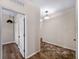 Hallway featuring hardwood floors, access to various rooms, and ample natural light at 10131 Winding River Rd, Punta Gorda, FL 33950