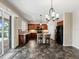 Open kitchen featuring dark wood cabinetry, granite countertops, and a spacious central island with barstool seating at 10131 Winding River Rd, Punta Gorda, FL 33950