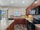 Well-lit kitchen featuring stone countertops, wooden cabinets, and stainless steel appliances at 10131 Winding River Rd, Punta Gorda, FL 33950