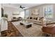 Elegant living room with hardwood floors, a plush sofa, and a marble-topped coffee table at 10131 Winding River Rd, Punta Gorda, FL 33950