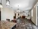 An open-concept living room with dark vinyl floors, natural light, and neutral color palette at 10131 Winding River Rd, Punta Gorda, FL 33950