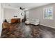 Cozy living room with a comfortable sofa, a wooden rocking chair, and a modern ceiling fan at 10131 Winding River Rd, Punta Gorda, FL 33950