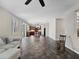 Spacious living room with an open floor plan, large windows, and a kitchen with dark wood cabinets at 10131 Winding River Rd, Punta Gorda, FL 33950