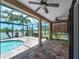 Covered and screened lanai featuring a swimming pool and scenic lake view at 10131 Winding River Rd, Punta Gorda, FL 33950