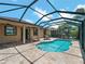 Screened-in pool area with a sparkling pool, paved patio, and comfortable outdoor seating at 10131 Winding River Rd, Punta Gorda, FL 33950