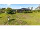Expansive backyard with a screened-in pool area and plenty of green space to enjoy at 11068 Jacqueline Ave, Englewood, FL 34224
