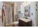 Full bathroom featuring a shower, vanity, lighting, and neutral-colored walls and patterned trim at 11068 Jacqueline Ave, Englewood, FL 34224