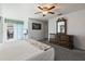 Bedroom features light walls, carpet floors, dresser and sliding glass door at 11068 Jacqueline Ave, Englewood, FL 34224