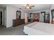 Large bedroom with carpet floors, dresser, ceiling fan and three windows for natural light at 11068 Jacqueline Ave, Englewood, FL 34224