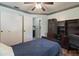 This bedroom features wood floors, custom built-ins, a ceiling fan and a view into the bathroom at 11068 Jacqueline Ave, Englewood, FL 34224