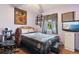 A cozy bedroom with lavender walls, wooden floors and a ceiling fan at 11068 Jacqueline Ave, Englewood, FL 34224