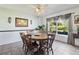 Cozy dining area with a round wooden table and large window offering natural light at 11068 Jacqueline Ave, Englewood, FL 34224