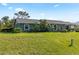Well-maintained home featuring a lush green lawn and decorative landscaping at 11068 Jacqueline Ave, Englewood, FL 34224