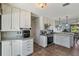 Stylish kitchen with granite countertops, stainless steel oven, and sleek white cabinets at 11068 Jacqueline Ave, Englewood, FL 34224