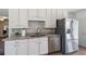 Updated kitchen with granite countertops, stainless steel appliances, and ample storage at 11068 Jacqueline Ave, Englewood, FL 34224