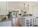 Bright, spacious kitchen with white cabinetry, stainless steel appliances, and tile flooring at 11068 Jacqueline Ave, Englewood, FL 34224