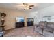 Cozy living room with decorative wallpaper, tile floors, ceiling fan, and an aquarium on display at 11068 Jacqueline Ave, Englewood, FL 34224