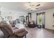 Inviting living area featuring tile flooring, a ceiling fan, and plenty of natural light at 11068 Jacqueline Ave, Englewood, FL 34224
