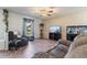 Comfortable living room with plush seating, tile floors, and a decorative ceiling fan at 11068 Jacqueline Ave, Englewood, FL 34224