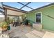 Screened patio featuring a seating area with greenery, offering a relaxing outdoor space at 11068 Jacqueline Ave, Englewood, FL 34224
