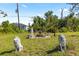 Yard featuring a stone water fountain and surrounding statue art on a sunny day at 11068 Jacqueline Ave, Englewood, FL 34224