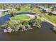 Scenic aerial view overlooking a golf course with lush green fairways, water features, and nearby residential community at 123 Annapolis Ln, Rotonda West, FL 33947