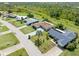 Drone view displaying neighborhood homes with green lawns, pools, mature landscaping, and long driveway at 123 Annapolis Ln, Rotonda West, FL 33947