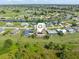 Aerial view of neighborhood highlighting the surrounding green lawns, waterways and community at 123 Annapolis Ln, Rotonda West, FL 33947