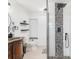 Bright bathroom showing walk-in shower with decorative stone wall, toilet and vanity with stone counter at 123 Annapolis Ln, Rotonda West, FL 33947