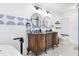 Bathroom boasting dual vanity with decorative tile accent, round mirrors, and freestanding tub at 123 Annapolis Ln, Rotonda West, FL 33947
