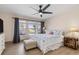 Inviting bedroom featuring ample natural light and hardwood floors, complemented by a ceiling fan at 123 Annapolis Ln, Rotonda West, FL 33947