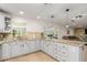 The kitchen is complemented by granite countertops, white cabinets, and an airy transition to the living area at 123 Annapolis Ln, Rotonda West, FL 33947