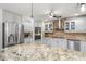 Bright kitchen with granite countertops, stainless steel appliances, custom cabinetry and oversized center island at 123 Annapolis Ln, Rotonda West, FL 33947