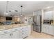 The kitchen flows into the living space featuring an oversized refrigerator and expansive granite counters at 123 Annapolis Ln, Rotonda West, FL 33947