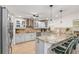 Bright kitchen features stainless steel appliances, granite countertops, bar seating and decorative tile backsplash at 123 Annapolis Ln, Rotonda West, FL 33947