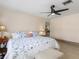 This main bedroom features a ceiling fan, wood look tile flooring, and doorway to the rest of the home at 123 Annapolis Ln, Rotonda West, FL 33947
