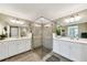 Luxurious bathroom with a glass enclosed shower and double sink vanity at 12425 Ghiberti Cir # 101, Venice, FL 34293