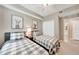 Inviting bedroom features twin beds, soft neutral walls, and charming animal artwork, creating a cozy retreat at 12425 Ghiberti Cir # 101, Venice, FL 34293