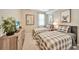 Cozy bedroom features two twin beds with stylish grey plaid comforters and charming animal artwork at 12425 Ghiberti Cir # 101, Venice, FL 34293