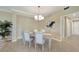 Neutral dining room showcases a chandelier, table with six chairs, and modern decor, bathed in natural light at 12425 Ghiberti Cir # 101, Venice, FL 34293