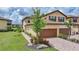 Beautiful two-story home featuring a well-manicured lawn, brick driveway, and an attached two-car garage at 12425 Ghiberti Cir # 101, Venice, FL 34293