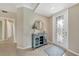 Inviting home foyer features a decorative glass door, stylish console table, and neutral color palette at 12425 Ghiberti Cir # 101, Venice, FL 34293